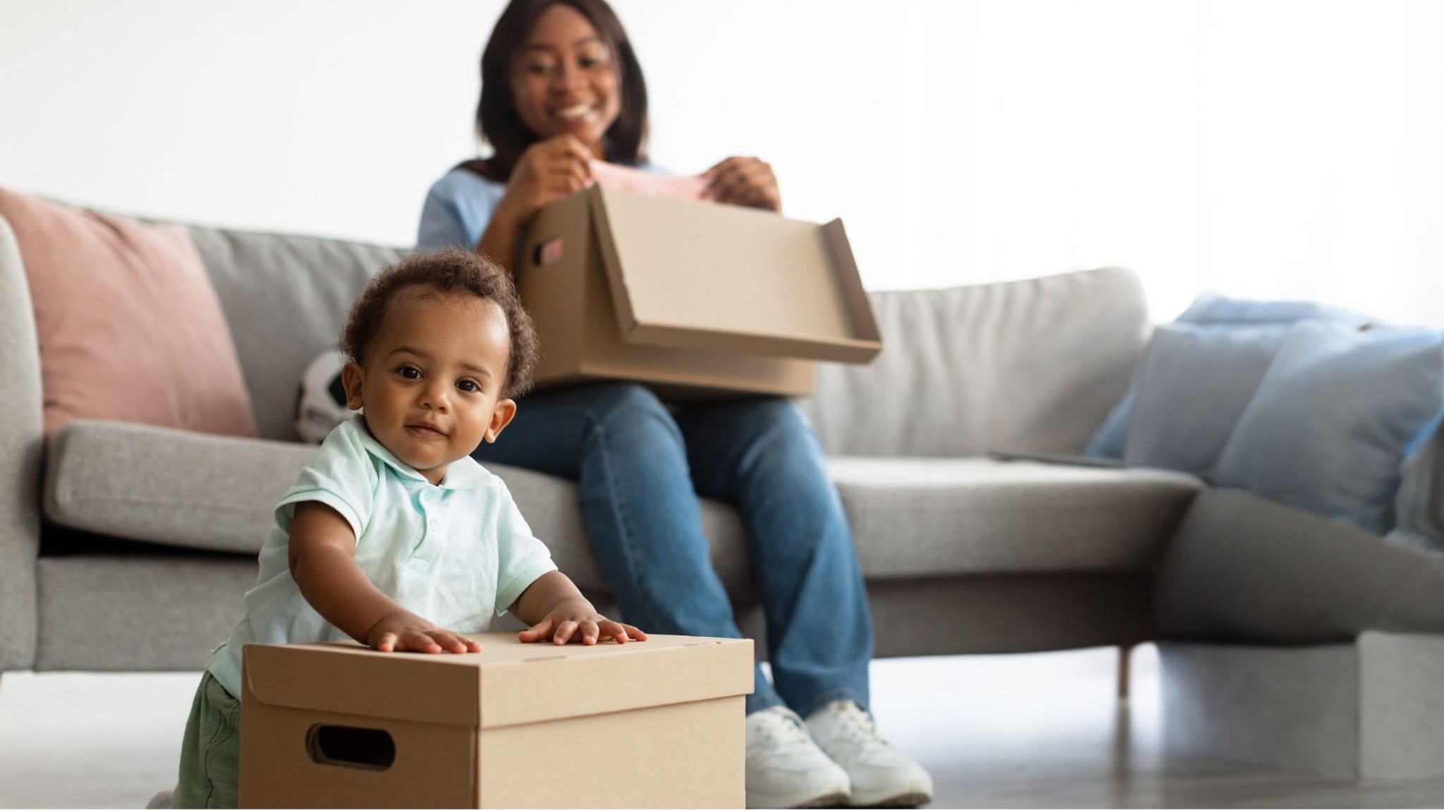 Young Black family settling into a home